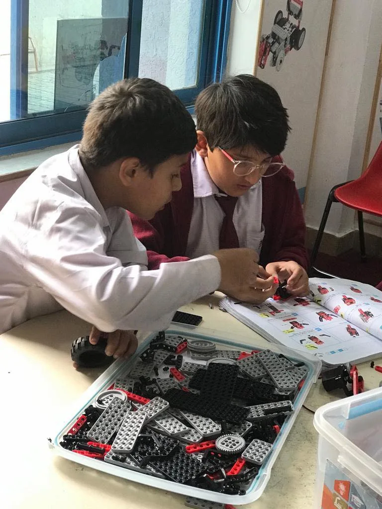 Two students working together on a robotics activity