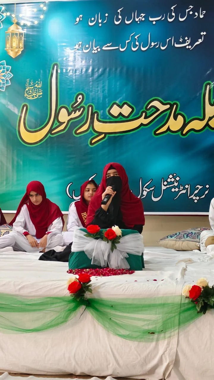 Students participating in an Urdu-language stage event